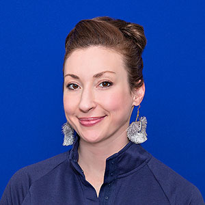 Jessie Torrey in navy top with silver earrings