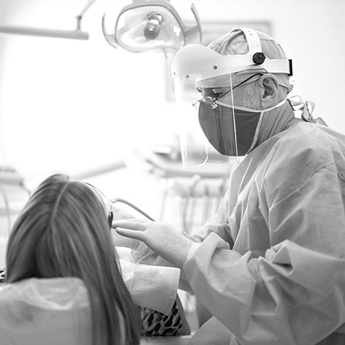 A dental professional working with a new patient