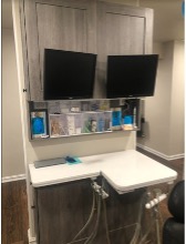 Two new computer monitors in a dental office after remodeling.