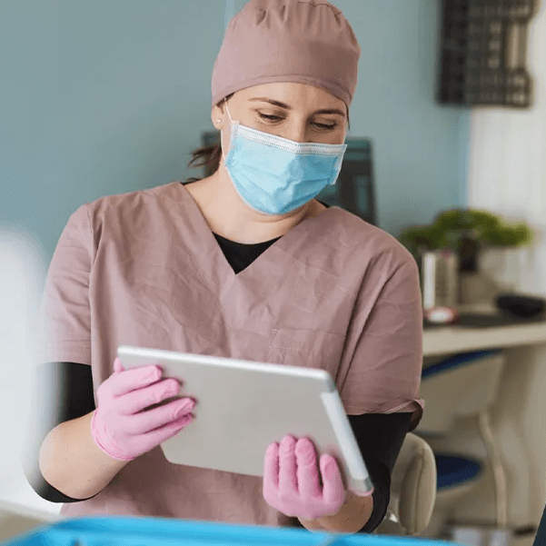 A dental assistant using a tablet
