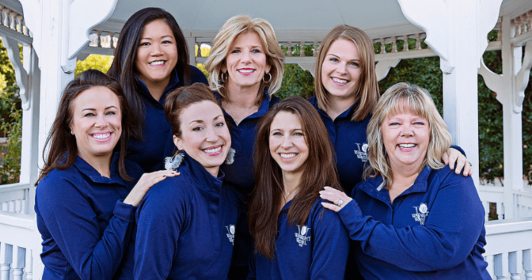 Team Debbie smiling in their blue uniform