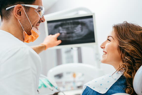 A hygienist explaining a dental term to a patient