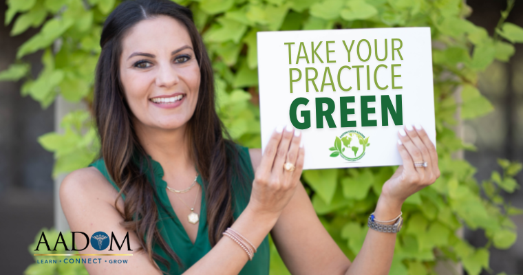 Jennifer Z. Vickery holding up a sign that says "Take Your Practice Green"