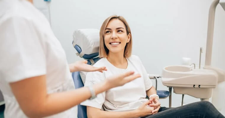 A female patient sitting in a dental chair